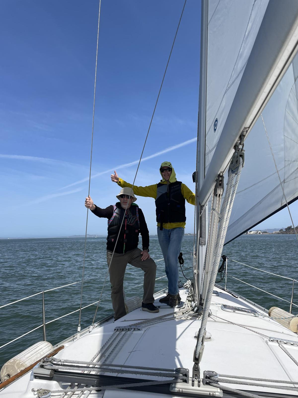 Guests standing by the sail on deck